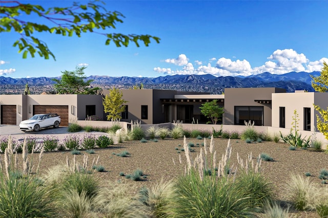 view of front of property featuring a garage, a mountain view, and stucco siding