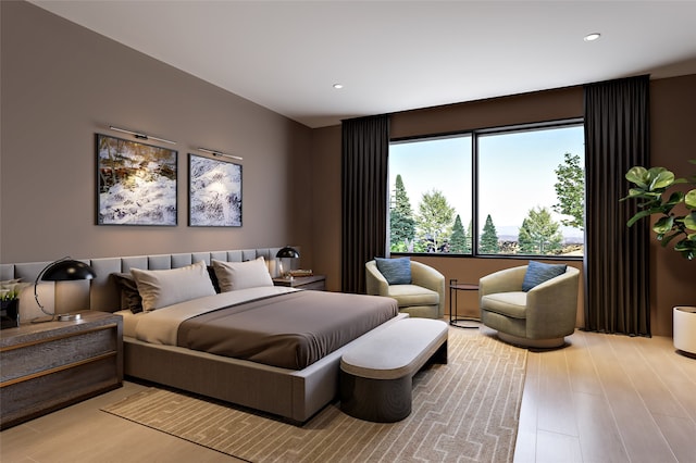 bedroom with light wood finished floors and recessed lighting