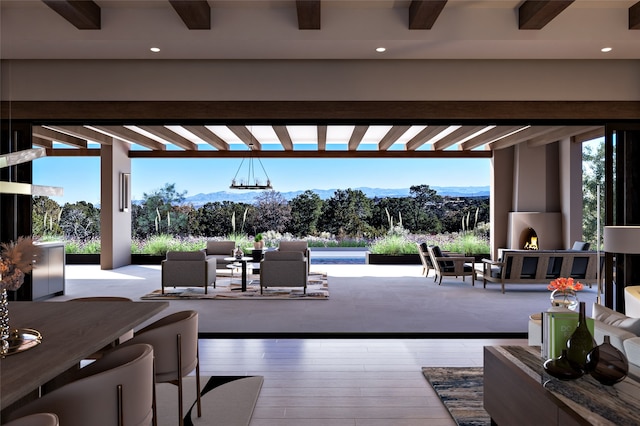 view of patio / terrace with an outdoor living space with a fireplace, outdoor dining area, a mountain view, and a pergola