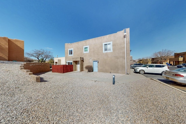 back of property featuring stucco siding