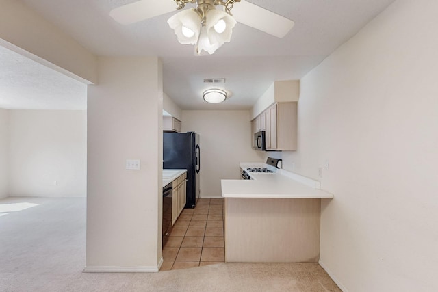 kitchen with light carpet, a peninsula, visible vents, light countertops, and black appliances