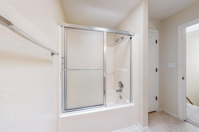 full bathroom featuring enclosed tub / shower combo, baseboards, and tile patterned floors