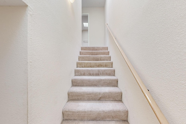 staircase with a textured wall