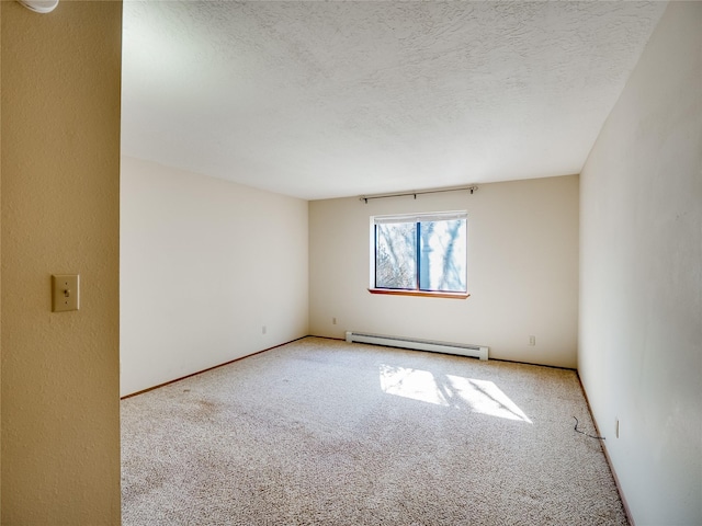 empty room featuring a baseboard radiator, carpet flooring, a textured ceiling, and baseboards