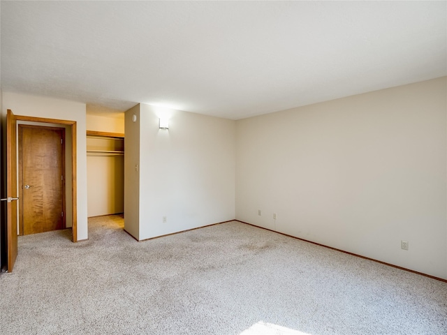 unfurnished bedroom featuring carpet floors and a closet