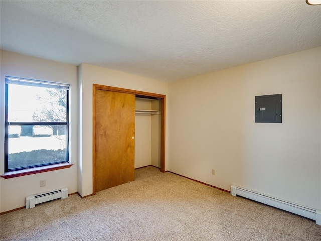 unfurnished bedroom featuring light carpet, baseboard heating, a closet, and electric panel