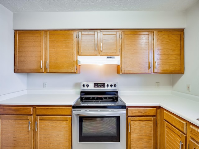 kitchen featuring a textured ceiling, stainless steel electric stove, ventilation hood, and light countertops