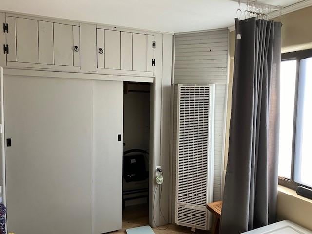 interior space featuring a heating unit and a closet