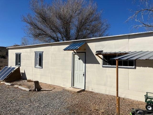 back of property featuring concrete block siding