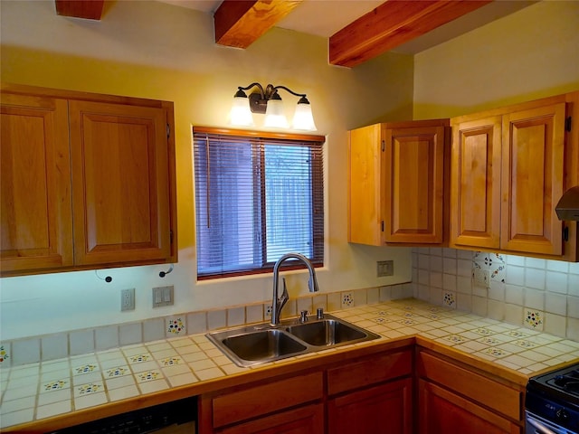 kitchen with tile countertops, beam ceiling, backsplash, and a sink