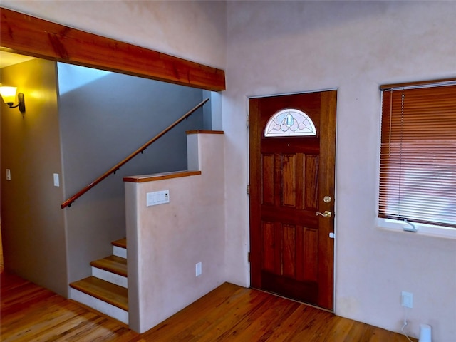 foyer entrance with stairway and wood finished floors