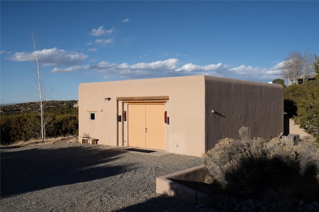 view of outdoor structure featuring a garage and an outbuilding