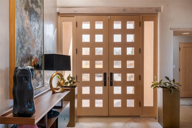 doorway to outside featuring french doors and light tile patterned floors