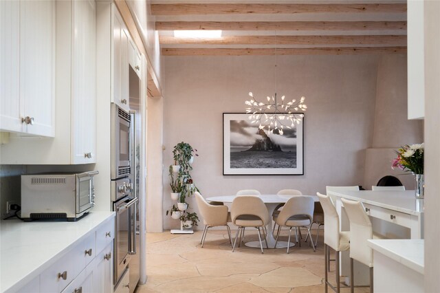 dining area featuring a toaster and a notable chandelier