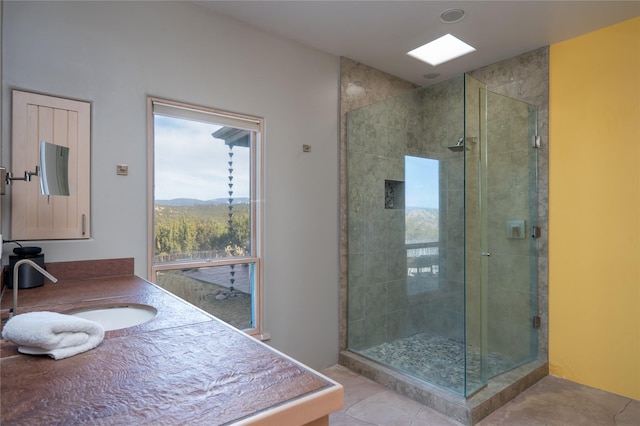 bathroom featuring a stall shower, tile patterned floors, and vanity