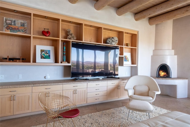 kitchen featuring light tile patterned floors, a fireplace, light countertops, open shelves, and beamed ceiling