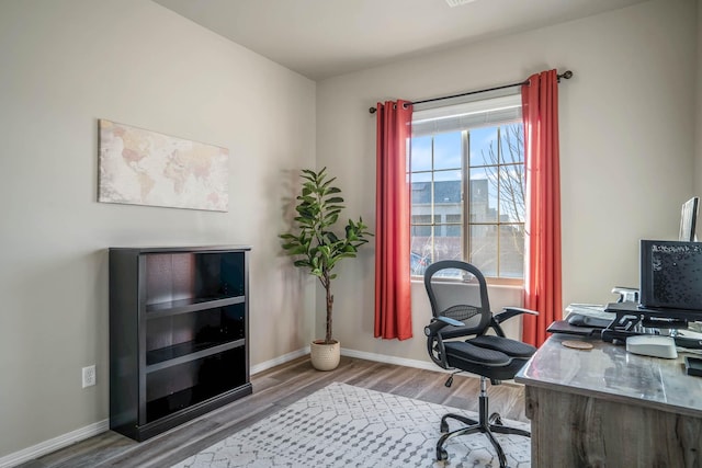 office featuring baseboards and wood finished floors