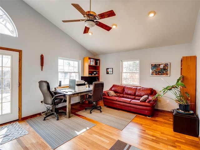 office area featuring wood finished floors, a wealth of natural light, and a ceiling fan