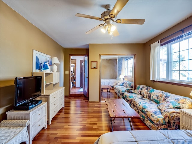 living area with light wood-type flooring and ceiling fan