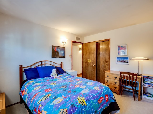 bedroom featuring carpet floors, visible vents, and a closet