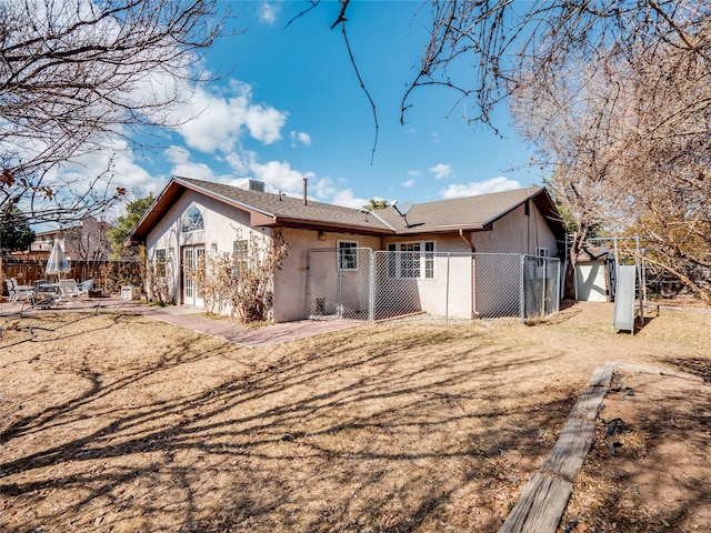 back of property with a patio area, fence, and stucco siding