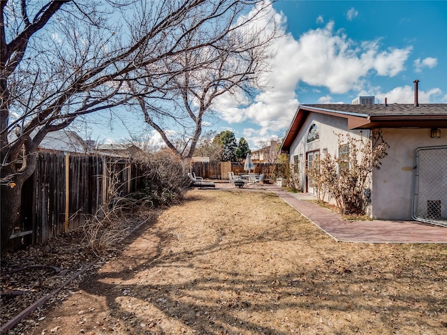 view of yard featuring a patio area and a fenced backyard