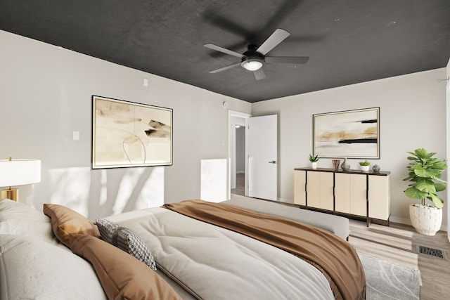 bedroom featuring visible vents, ceiling fan, and light wood-style flooring