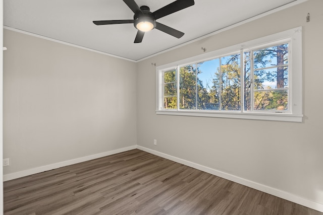 unfurnished room with crown molding, baseboards, ceiling fan, and wood finished floors