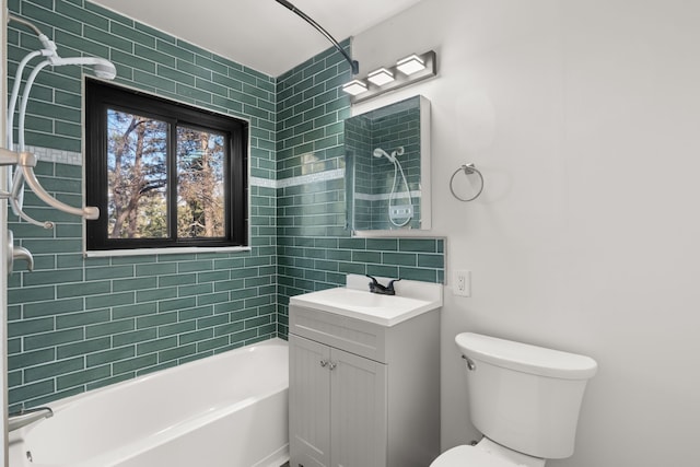 bathroom featuring toilet, shower / washtub combination, and vanity