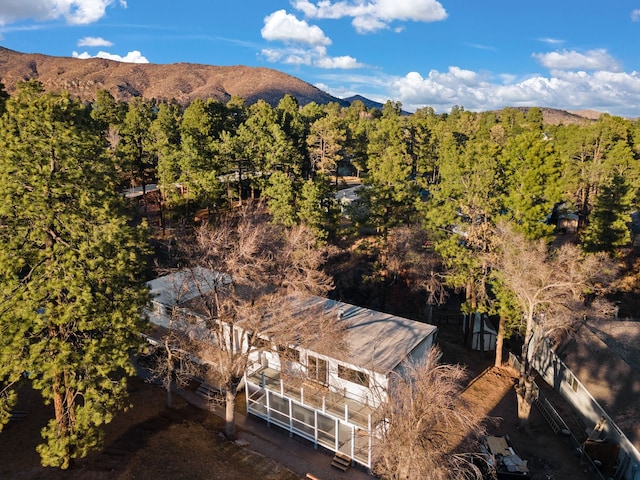 birds eye view of property with a mountain view and a wooded view