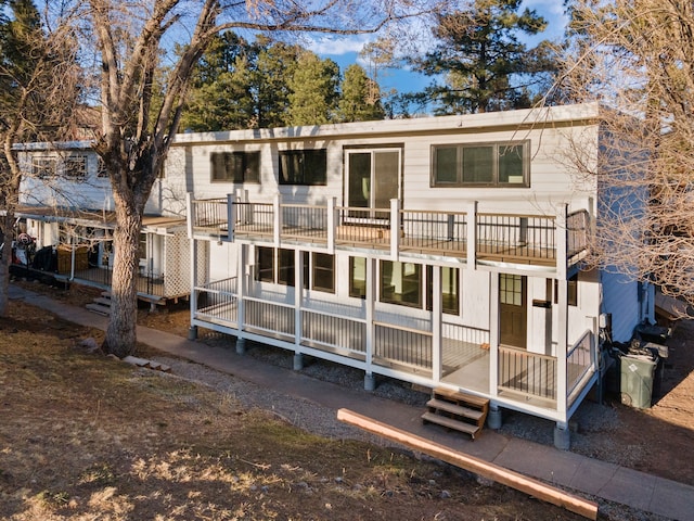 back of house featuring a balcony