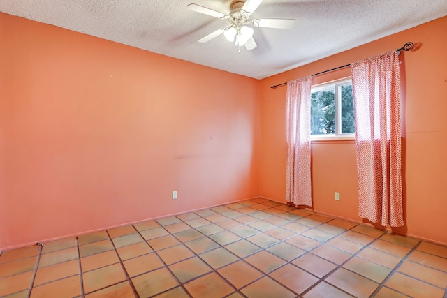 unfurnished room featuring a ceiling fan, a textured ceiling, and light tile patterned floors