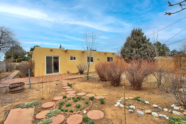 rear view of property with stucco siding