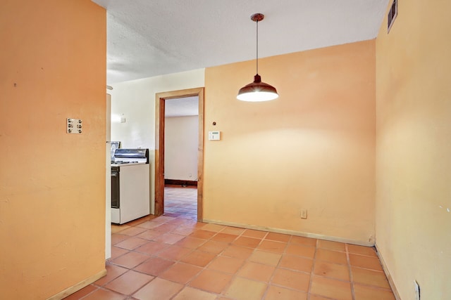 interior space with visible vents, a textured ceiling, baseboards, and light tile patterned floors