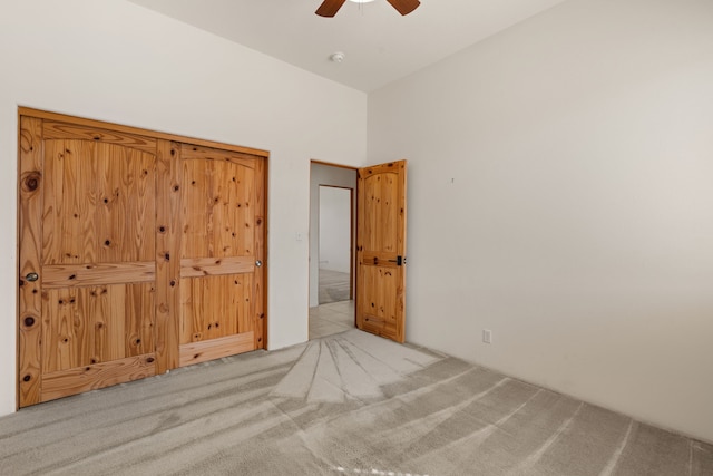 unfurnished bedroom featuring carpet flooring and a ceiling fan