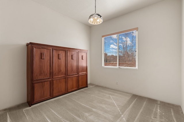 unfurnished room featuring light carpet