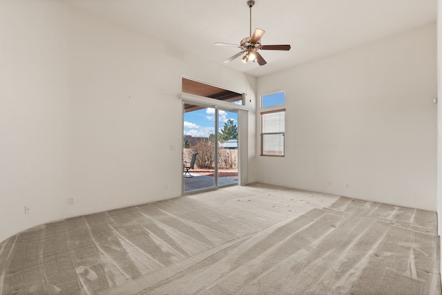 empty room featuring a ceiling fan and carpet flooring