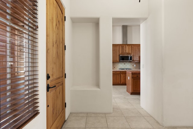 corridor featuring light tile patterned floors