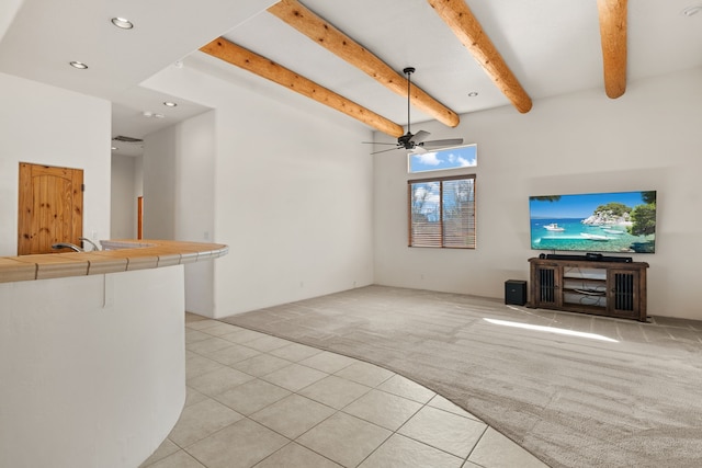 unfurnished living room with recessed lighting, light tile patterned flooring, beam ceiling, and light colored carpet