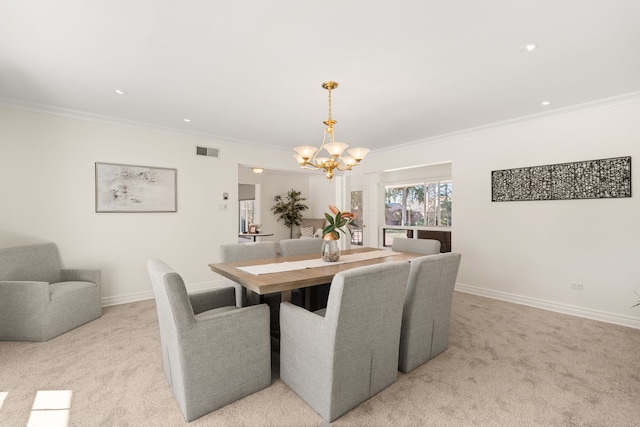 dining room featuring crown molding, light colored carpet, visible vents, an inviting chandelier, and baseboards