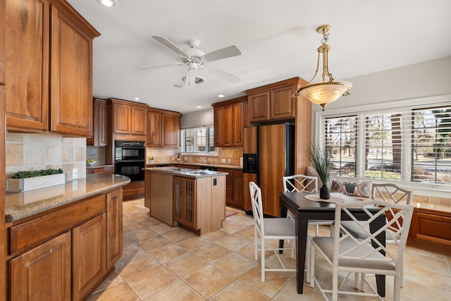 kitchen featuring dobule oven black, fridge with ice dispenser, brown cabinets, and backsplash