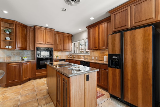 kitchen featuring light tile patterned floors, black appliances, brown cabinetry, and visible vents