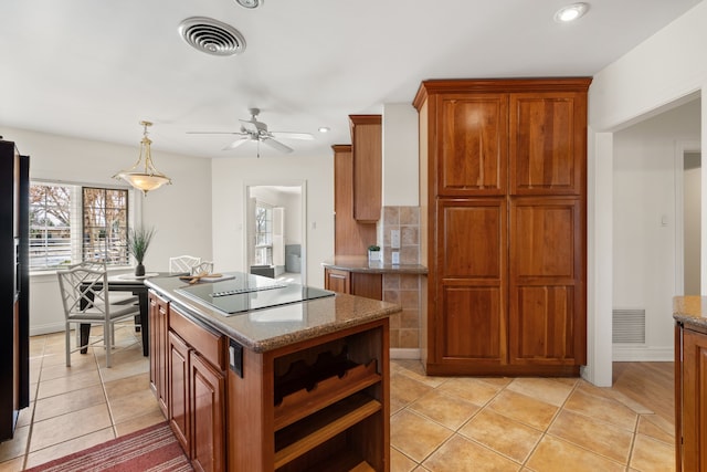 kitchen with light tile patterned floors, black appliances, visible vents, and brown cabinets