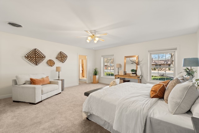 bedroom with light carpet, visible vents, baseboards, and multiple windows