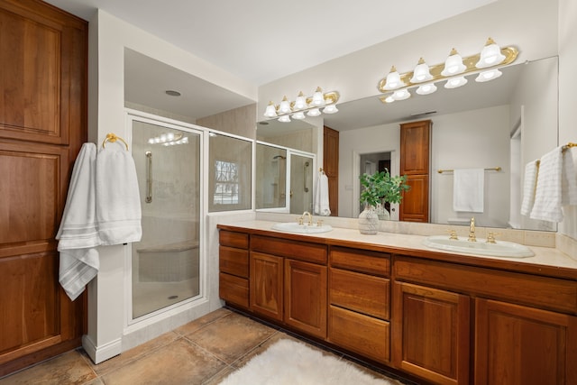 full bath with double vanity, a stall shower, a sink, and tile patterned floors