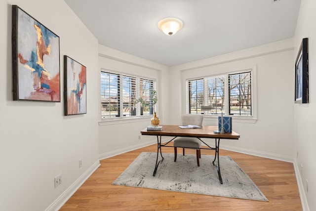 office space with light wood-style flooring and baseboards