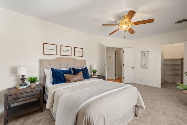 bedroom featuring light colored carpet, visible vents, ceiling fan, and baseboards