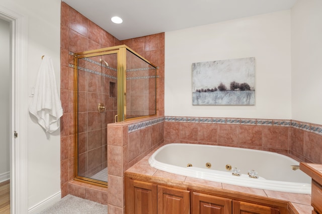 bathroom featuring a whirlpool tub and a stall shower