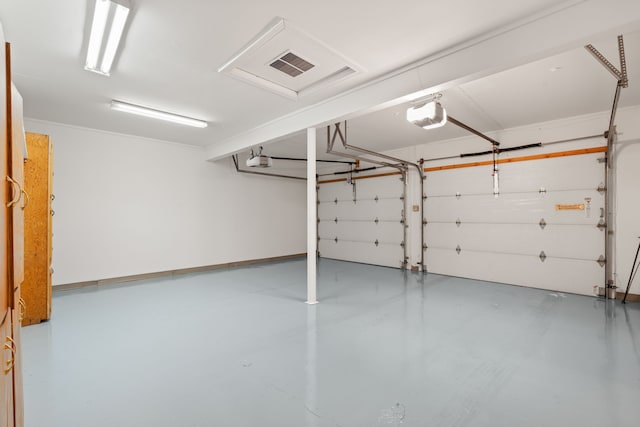 garage featuring visible vents and a garage door opener