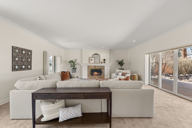 living area featuring light carpet, ornamental molding, and a tile fireplace